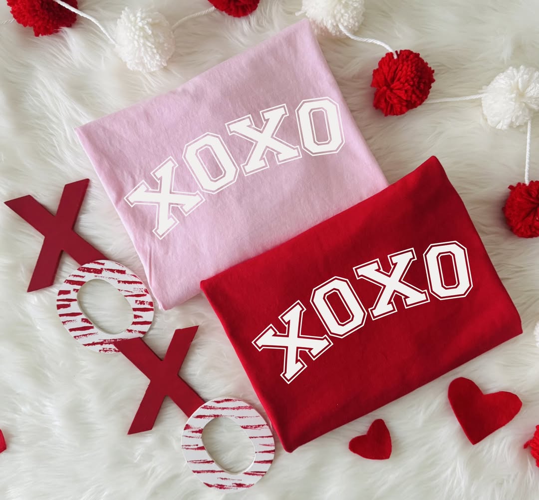 Pink and Red XOXO Valentine's Day Varsity Graphic T-shirts on white faux fur background